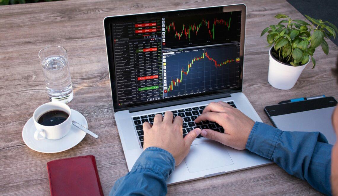 Line and candlestick forex charts with trading course annotations on screen
