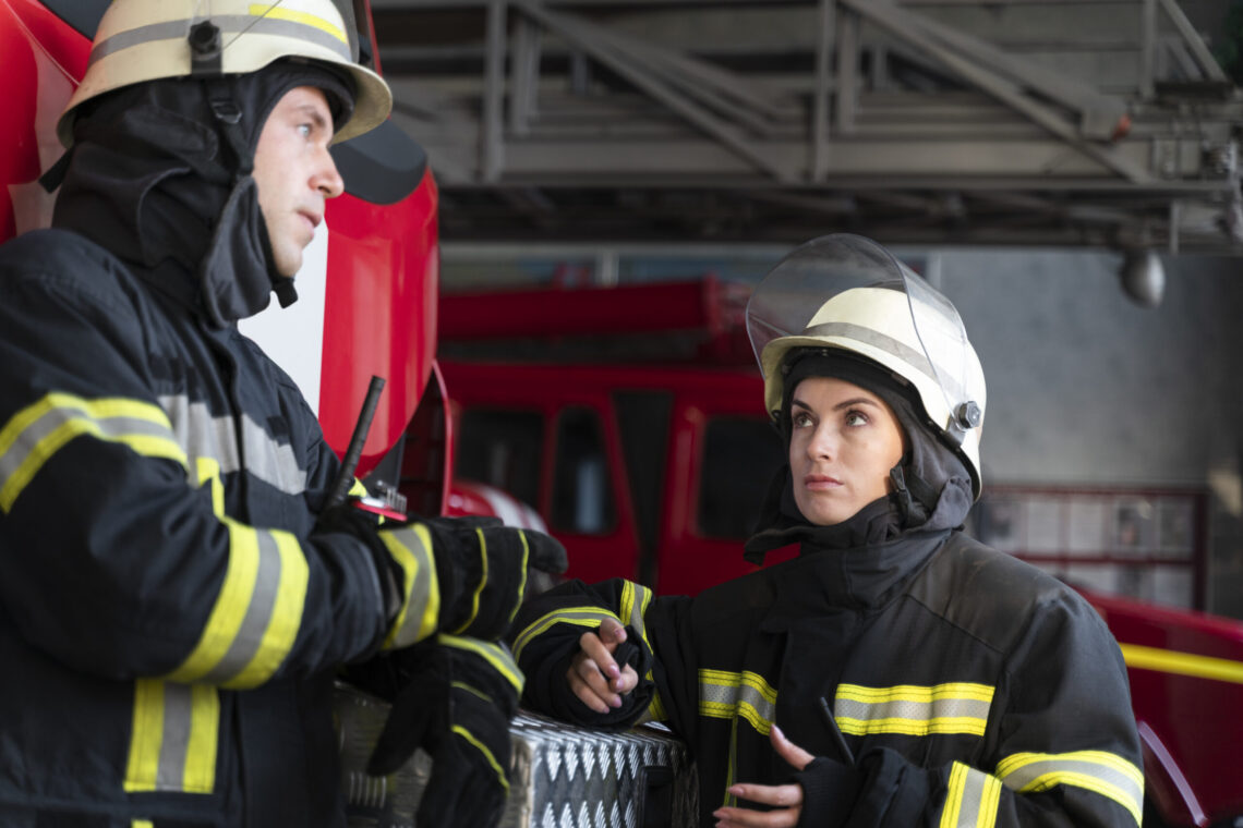 male female firefighters working together suits helmets scaled 1