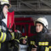 male female firefighters working together suits helmets scaled 1